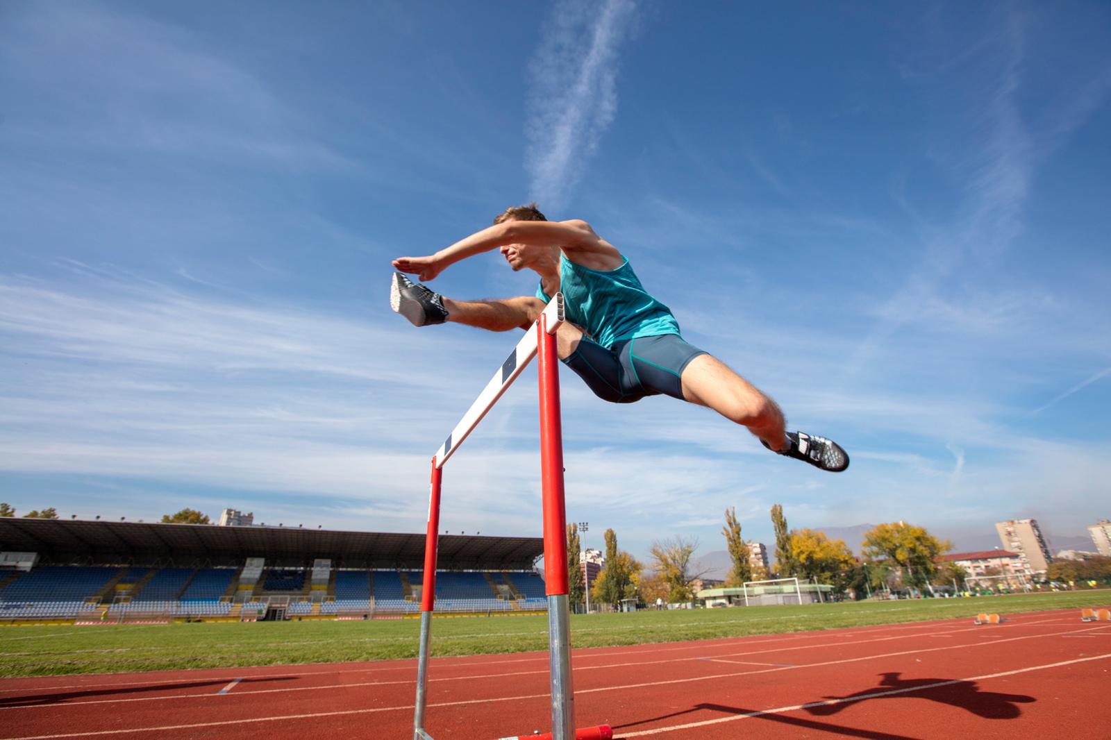 Athlete clearing a hurdle