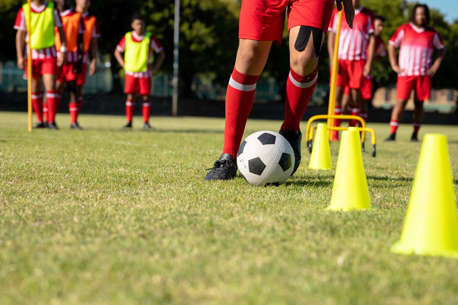Footballer practising close control between cones