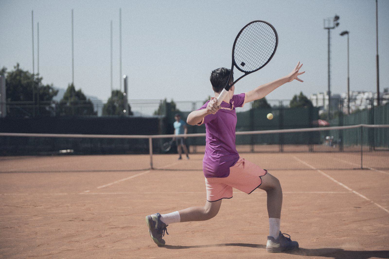Young tennis player hitting a forehand